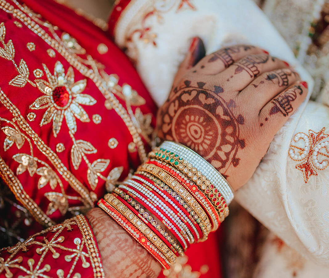 Bride and husband holding hands in an Indian wedding.