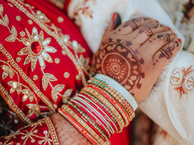 Bride and husband holding hands in an Indian wedding.