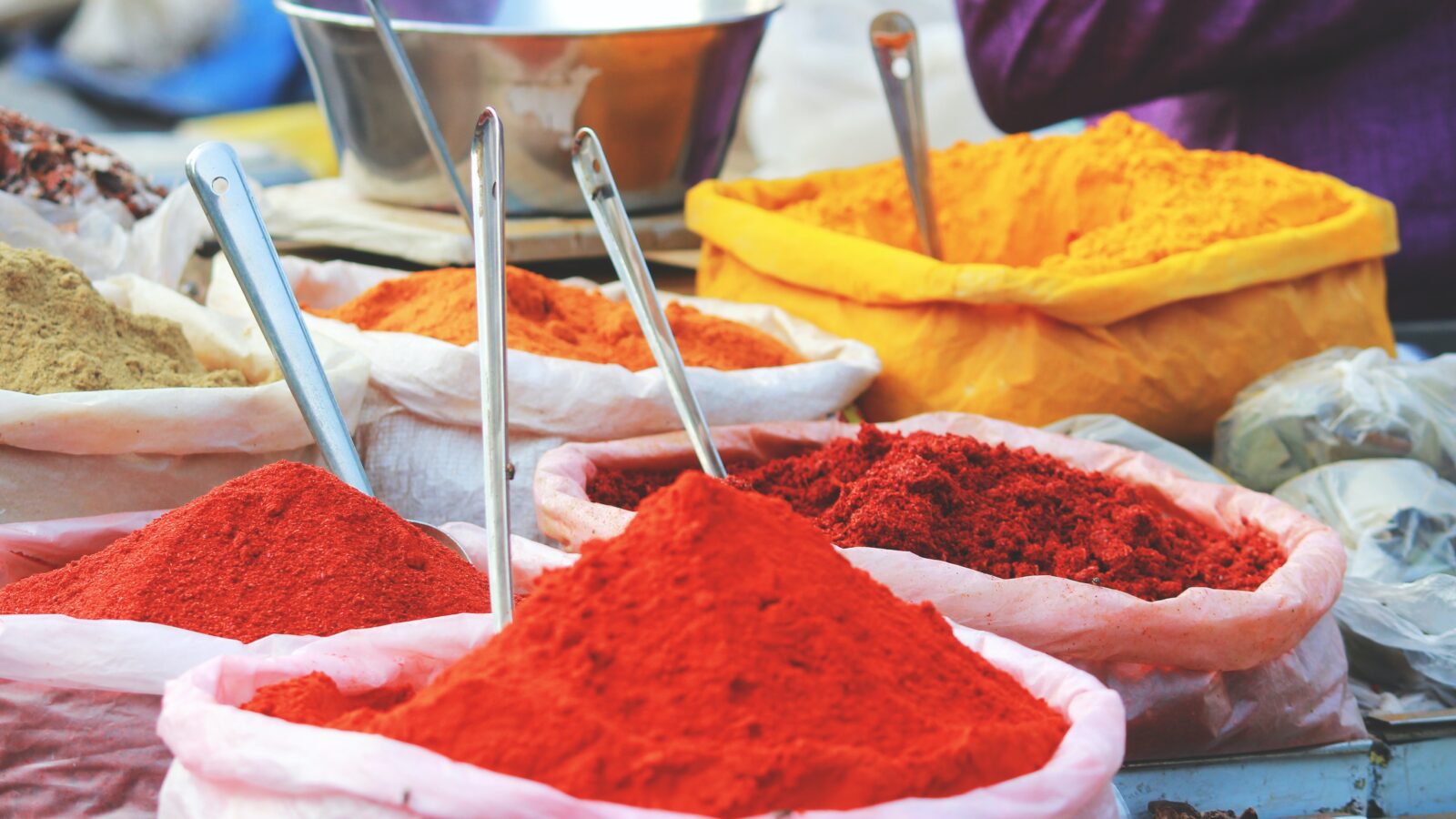 Mounds of colored powder. Credit Akhil Chandran, Unsplash.